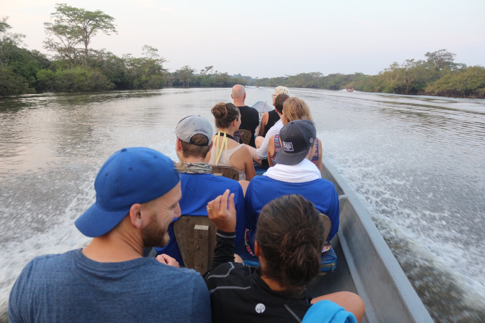 Group navigating to Cuyabeno Dolphin Lodge by motorized canoe