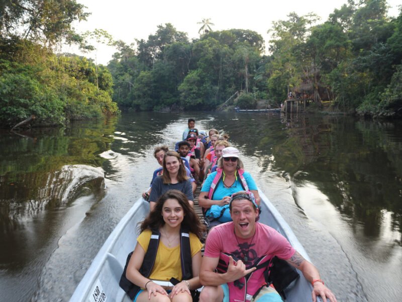 Travelers navigating the Cuyabeno River by motorized canoe